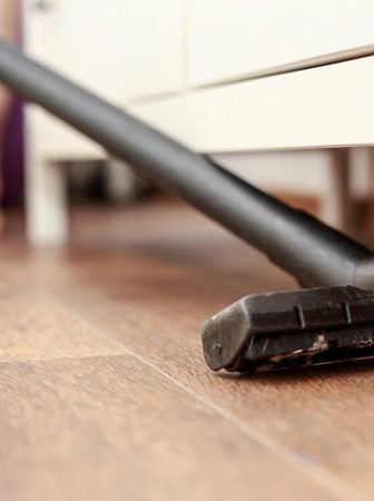 Vacuuming-under-furniture-getting-rid-of-dust-bunnies